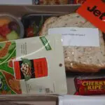 A box of food with some crackers and other items