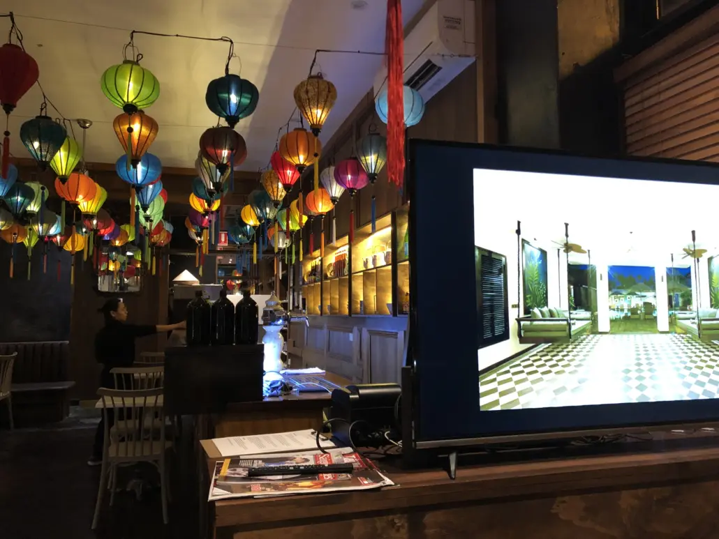 A television screen in the middle of an empty restaurant.