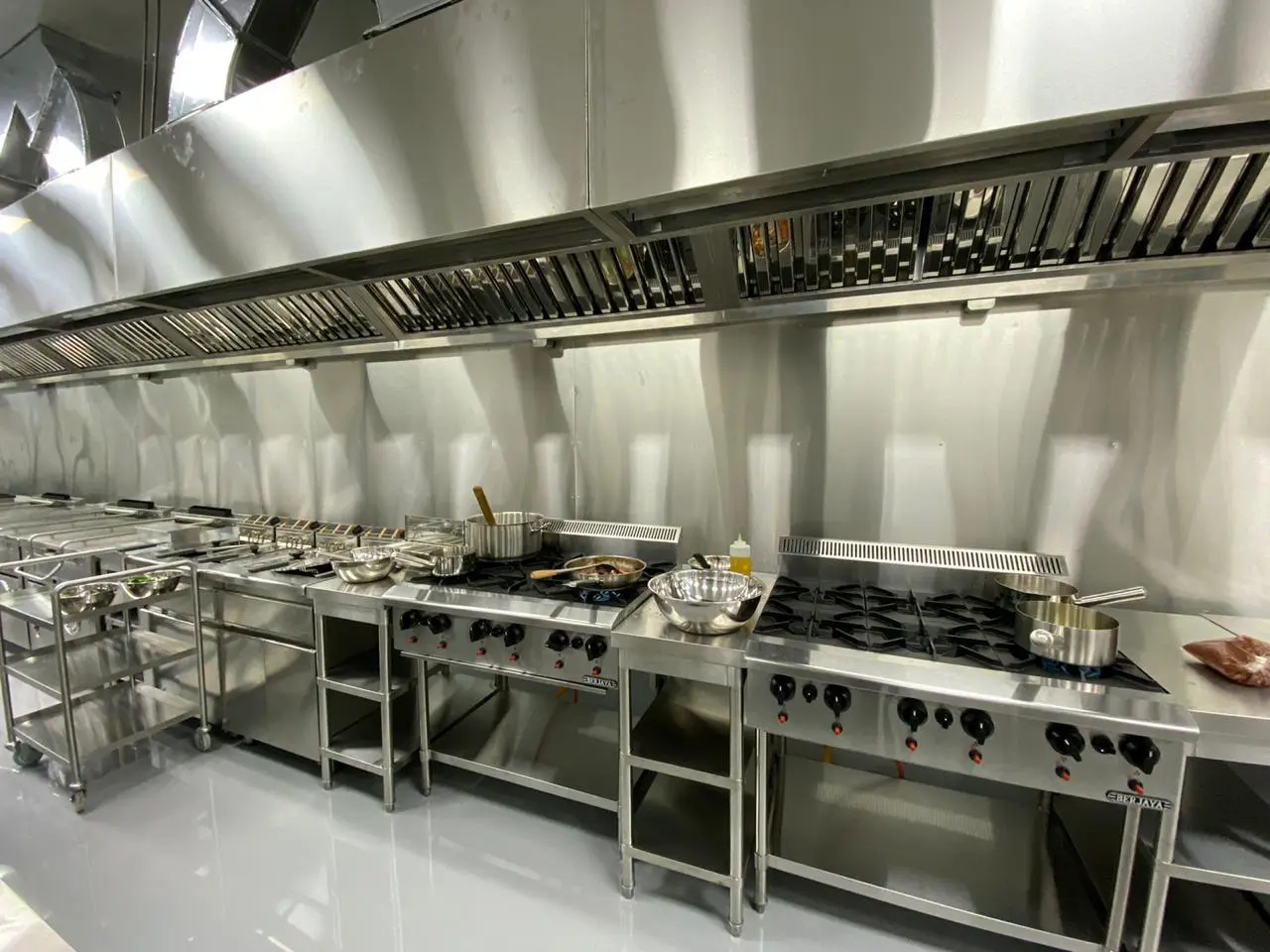 A kitchen with many different types of cooking equipment.