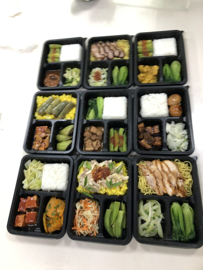 A bunch of trays that are filled with food