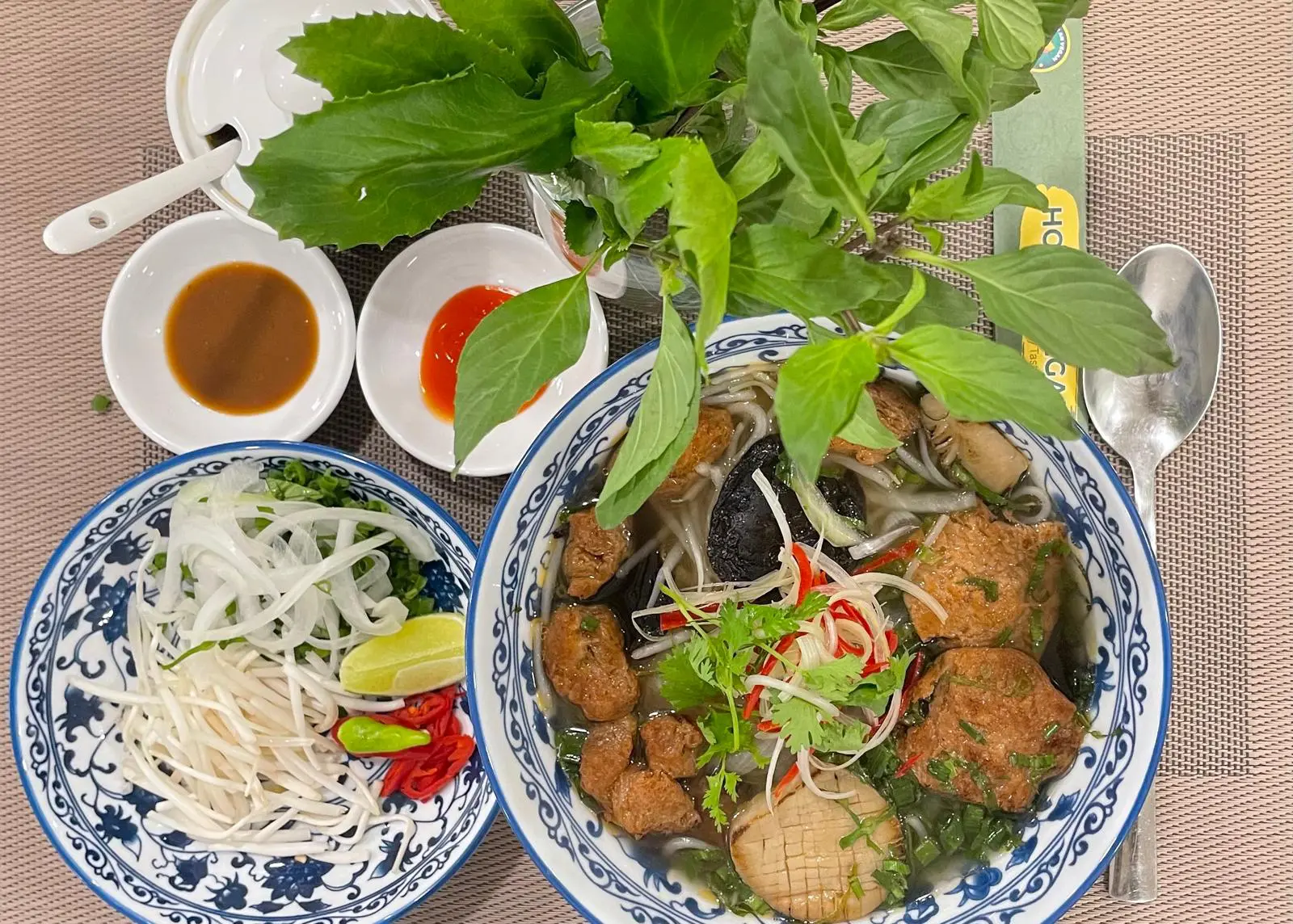 Bowl of Vietnamese Pho with toppings.